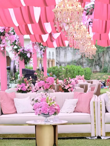The guest seating area continued the pink theme with plush sofas, elegant chandeliers, and draped fabric ceilings, ensuring every part of the venue felt cohesive and luxurious.