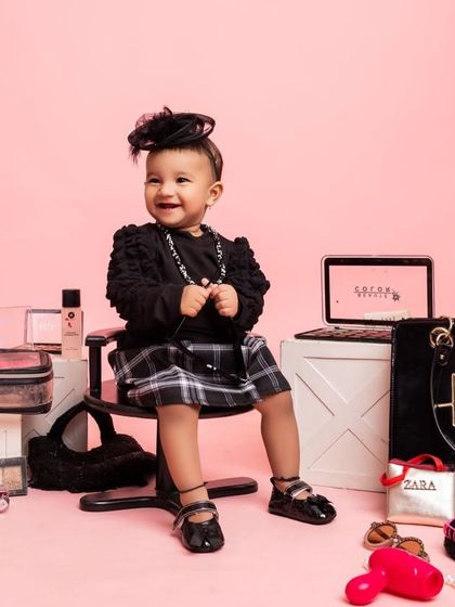 A 'One-derful' setup for a little fashionista's first birthday. This theme is all about style, with props like designer bags, makeup, and a mini laptop.