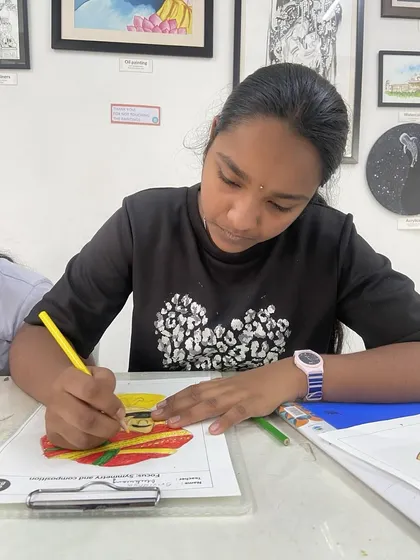 A student carefully adds color to her drawing during one of our offline classes. We provide step by step guidance and interactive worksheets to make learning art both easy and fun.