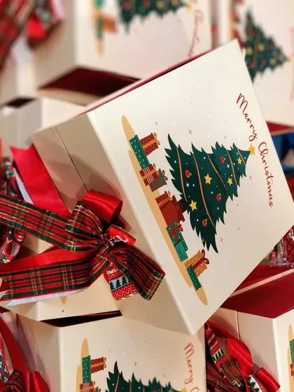 "Spread the Cheer" Christmas boxes custom-made for a prestigious law firm. These festive boxes, featuring a Christmas tree design, were filled with goodies and delivered all over Mumbai.