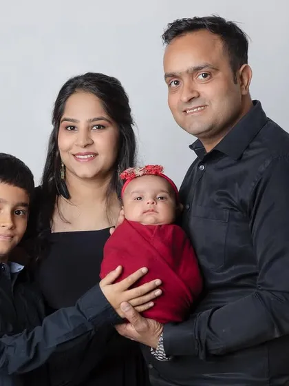 The complete family, including the older brother proudly holding his new baby sister. A heartwarming moment.