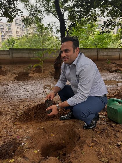 A volunteer from Calpro Specialities carefully plants a sapling at the Aravali Creek. His focused effort is a small but significant part of the creek's revival.