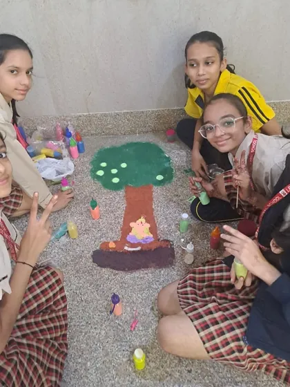 Students collaborate on a rangoli design depicting a tree, blending environmental themes with festive art. We encourage creative thinking that connects different aspects of their learning.