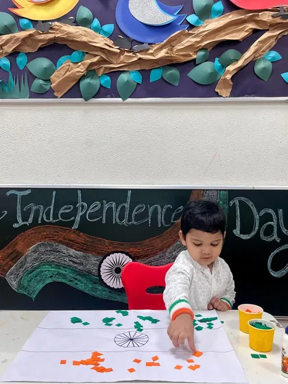 With intense concentration, one of our little stars participates in an Independence Day flag-making activity, learning about colours and shapes in a meaningful context.