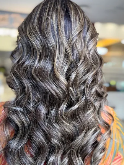 A balayage with brown, blonde, and face-framing highlights. This look is perfect for the festive season, adding a touch of glamour and fun.