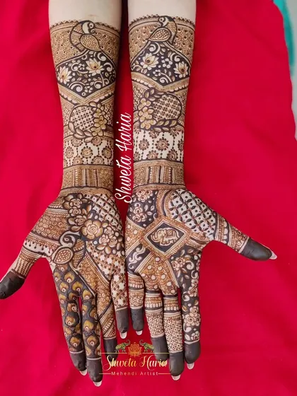 A heavy Indian design with a mix of many traditional elements. This piece includes peacocks, floral patterns, and various styles of checkwork (jaali) for a rich and diverse texture.
