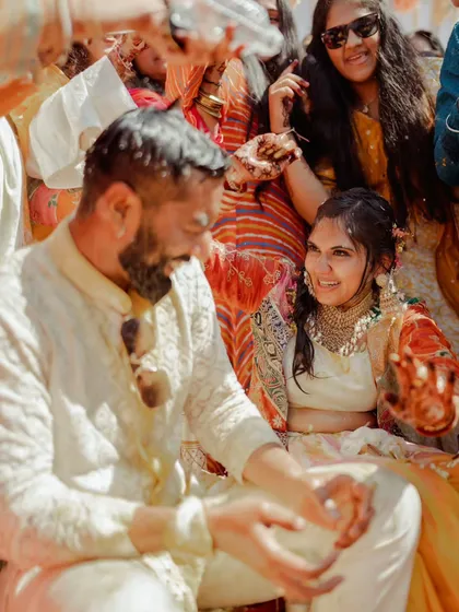 A candid moment of laughter between the couple during their Haldi. These are the genuine interactions that make the best memories.