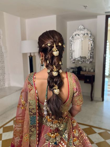 A detailed shot of the heavily accessorized braid, with each gold ornament carefully placed along its length.