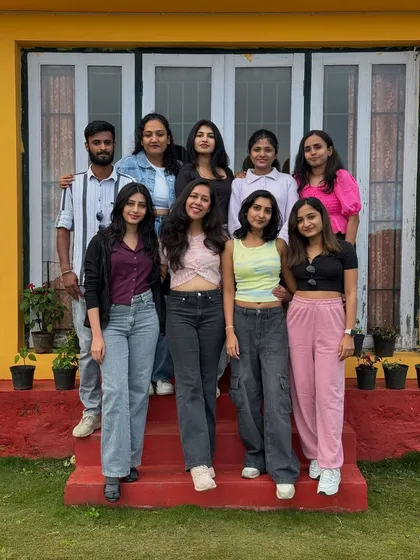 Another group shot on the steps of our cheerful yellow homestay.
