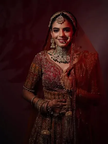 A soft and romantic bridal portrait from a lookbook shoot. I created a gentle updo that supports the dupatta and maang tikka without feeling too severe, resulting in a timeless and elegant bridal style.