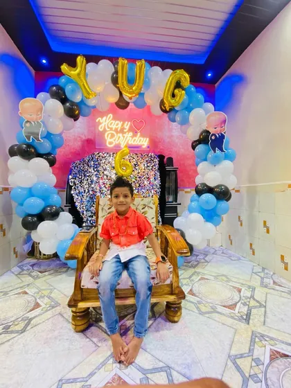 The birthday boy Yug enjoying his Boss Baby themed party setup. This shows how my decorations create the perfect photo opportunity.