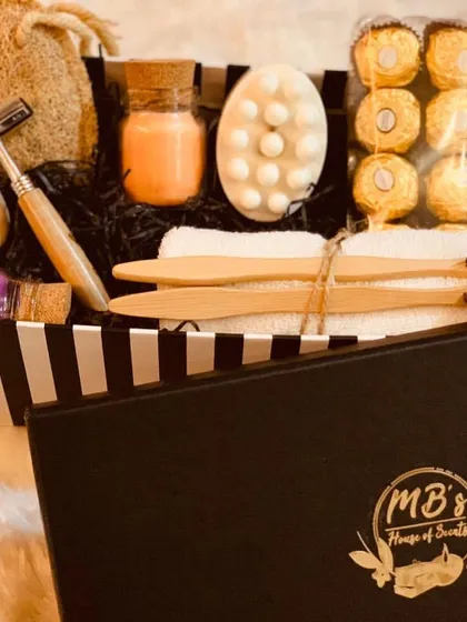 This personalized Valentine's box is designed for couples. It includes two candles, natural soaps, a massage bar, bamboo toothbrushes, a bamboo razor, and chocolates, making it a complete pampering experience to share.