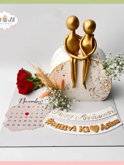 A bespoke anniversary cake celebrating "Marvi Ki Ashan." This artistic design features a calendar, a single red rose, and abstract couple toppers.