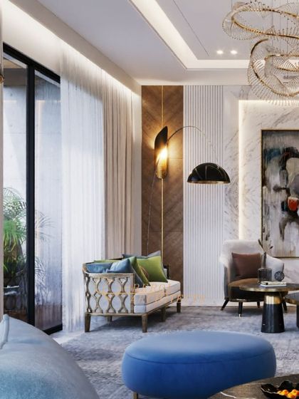 A living room that makes a bold statement with its mix of colors, textures, and artistic elements. The sculptural chandelier is a work of art, while the blue and green furniture adds vibrant energy.