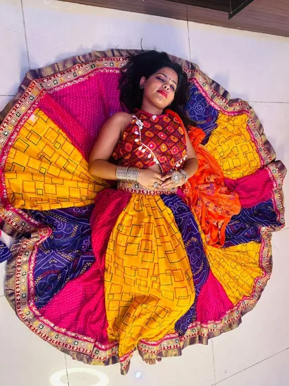 A beautiful overhead shot capturing the vibrant colors and patterns of the patchwork Garba lehenga.