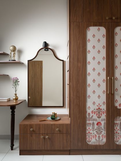 A different version of the same custom wardrobe and vanity unit, this time with a traditional block-print fabric on the doors, adding a touch of Indian craft to the space.