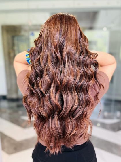 A beautiful display of hazelnut hues with caramel undertones, creating a warm and inviting hair color.