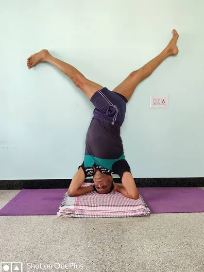 Parivrtta Eka Pada Shirshasana (Revolved One-Legged Headstand). This twisting variation in headstand requires immense core strength and a refined sense of balance.