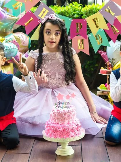 A fun and lively birthday party photoshoot. The siblings make funny faces for the camera, perfectly capturing the energy and excitement of a kid's celebration.