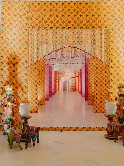 The grand entrance to a vibrant Garba night in Udaipur. I used traditional fabrics, colorful puppets, and intricate floral arrangements to create an immersive, festive atmosphere that set the stage for an unforgettable night of dance.