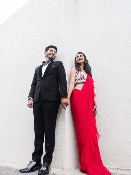 A duplicate of image 17, a modern and stylish couple pose against a minimalist white wall.