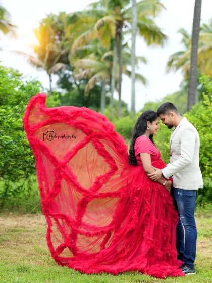 A dramatic flying gown shot with a red ruffled dress. This pose creates a sense of movement and grandeur in our outdoor location.
