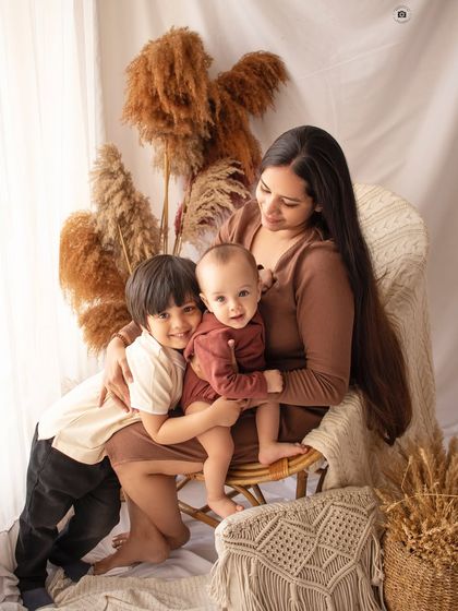 A loving family portrait with mom and her two boys. The older brother's sweet hug is a perfect example of sibling love.