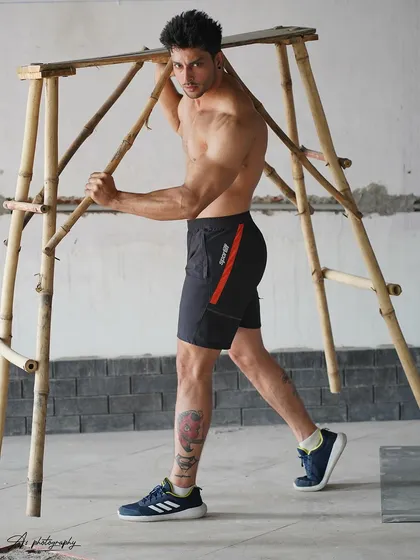 A side-profile physique shot that showcases the definition in the model's back, glutes, and legs. The pose is both athletic and aesthetic, perfect for fitness modeling.