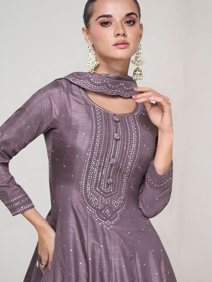 This dusty purple premium silk gown is modern and chic. The unique neckline and subtle sequin work make it a sophisticated choice for any formal event.