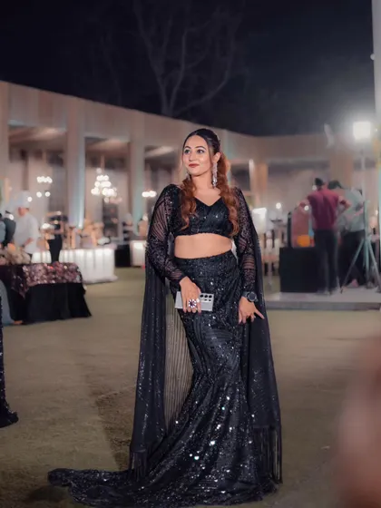 A full look at my custom black sequin outfit. The mermaid-style saree-drape pants with the cape sleeves were both comfortable and incredibly stylish.
