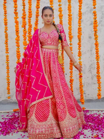 A vibrant pink lehenga that’s perfect for a fun wedding event. The traditional patterns and bright color will make you stand out in the best way.