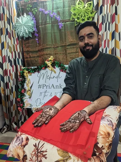 A happy groom showing his full mehendi design. This is a great option for grooms who want to participate fully in the tradition.