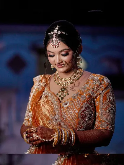 A modern bridal look in a stunning orange lehenga, perfect for a bride who wants a pop of color.