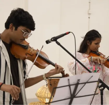 Two of our violin students performing a duet. The showcase features a variety of musical talents, including classical instruments, highlighting the breadth of our music education programs.