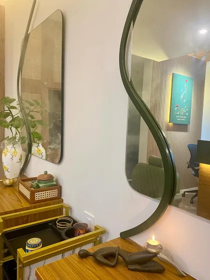The gentle glow of a candle and the reflection in our custom mirrors create a serene atmosphere in the salon.