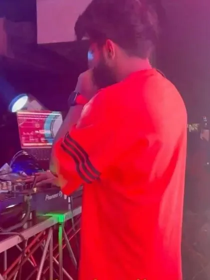 A shot of me in a bright red shirt, on the mic at Social Koramangala.