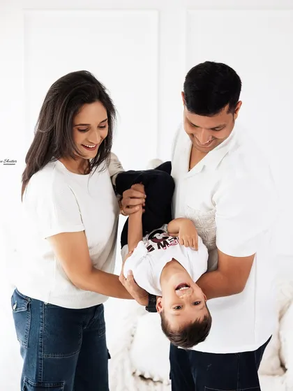 We live for the in-between moments, the playful tumbles and genuine laughter. This candid family photograph captures the wild, beautiful chaos that makes your family's story so special and real.