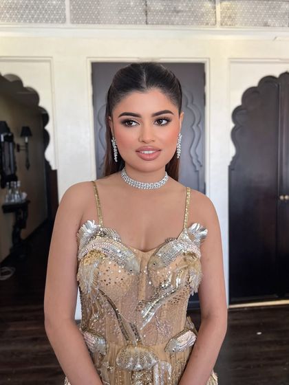 A close-up of the bride, her sleek hair complementing her modern, embellished gown.