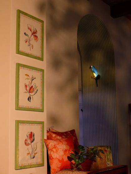 A trio of my custom floral wall art, framed in green, adds a touch of charm to this cozy nook. The soft, botanical illustrations are perfect for creating a relaxed and personal atmosphere.