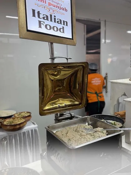 An Italian food station featuring a creamy pasta dish. We bring the authentic taste of Italy to your celebrations with our classic recipes.