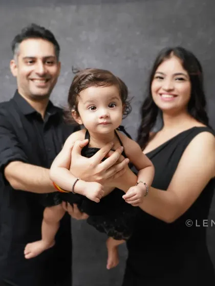 A classic family portrait against a simple backdrop. The focus is entirely on the family and the bond you share.