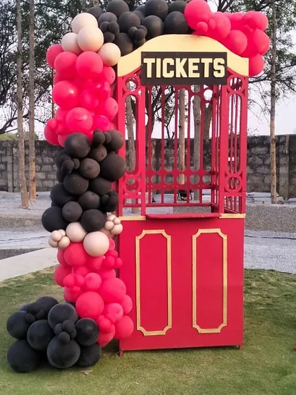 A close-up of the ticket booth from our vintage train station theme. This custom-built prop, complete with a "Tickets" sign and balloon accents, adds an interactive and authentic element to the immersive party experience.