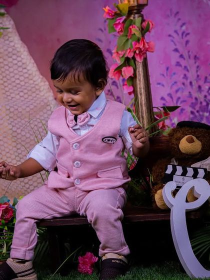 A soft and gentle first birthday theme in our pastel garden. The large "One" sign, teddy bear, and bench create a sweet scene for capturing this important milestone.