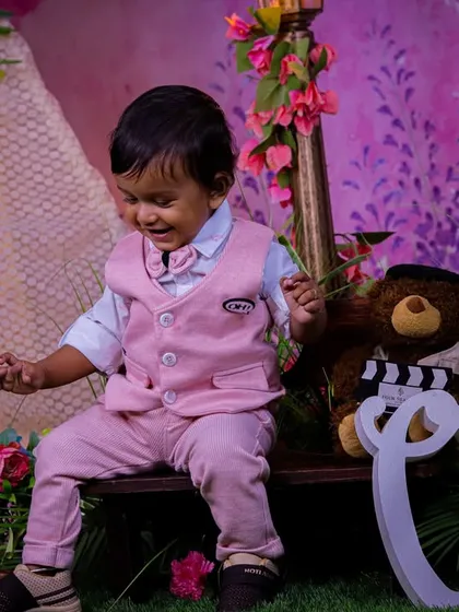 A soft and gentle first birthday theme in our pastel garden. The large "One" sign, teddy bear, and bench create a sweet scene for capturing this important milestone.