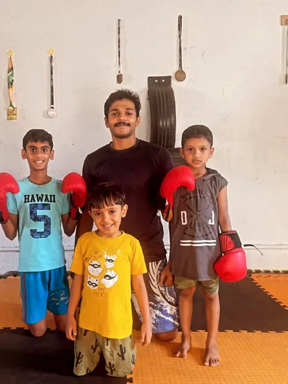 A group of young students ready for their boxing class. We aim to instill not just fighting skills, but also the spiritual and disciplinary aspects of martial arts.