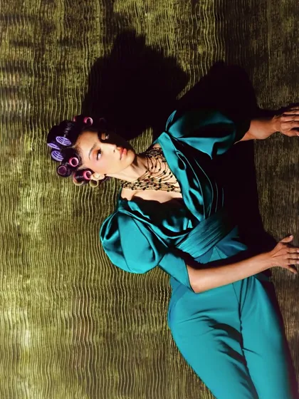 Another angle from the 'Vibrant Retroad' shoot, playing with dramatic shadows and light. The makeup and hair styling are key to establishing the vintage mood.