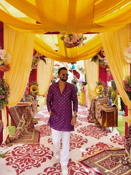 A candid shot of me walking through a beautifully decorated Mehendi venue. My outfit always matches the vibe of the event.