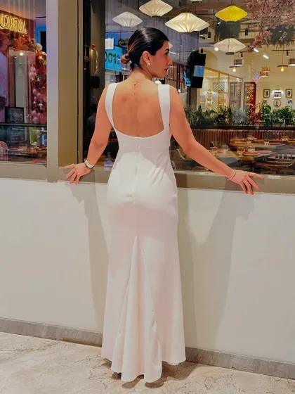 Looking out a window in my styled white dress. It's not about the dress, it's about the image you project.