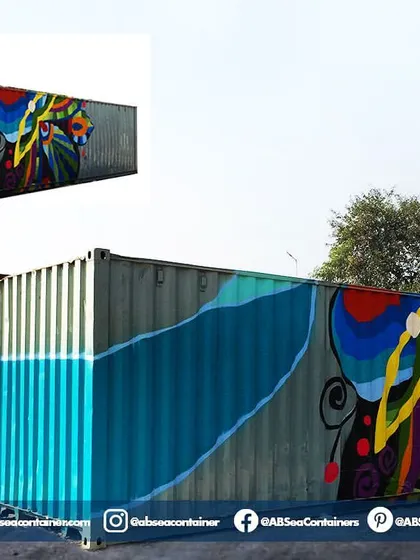 A shipping container serves as a blank canvas for creativity. This container features vibrant, custom-painted artwork, turning an industrial object into a piece of public art for an event.
