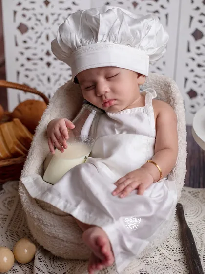 A little high on milk! This tiny baker has fallen asleep on the job, dreaming of sweet treats.
